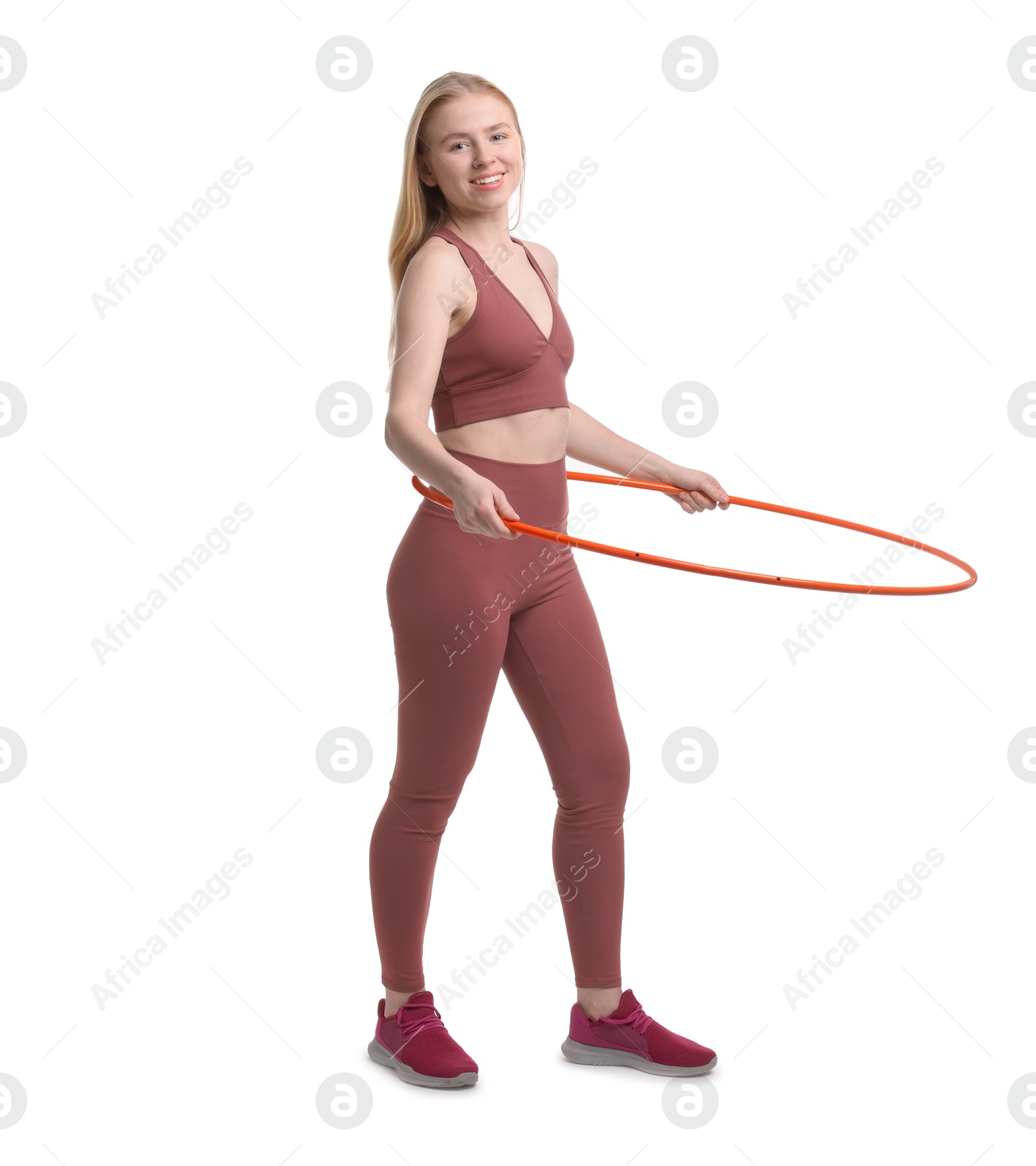 Photo of Beautiful young woman exercising with hula hoop on white background