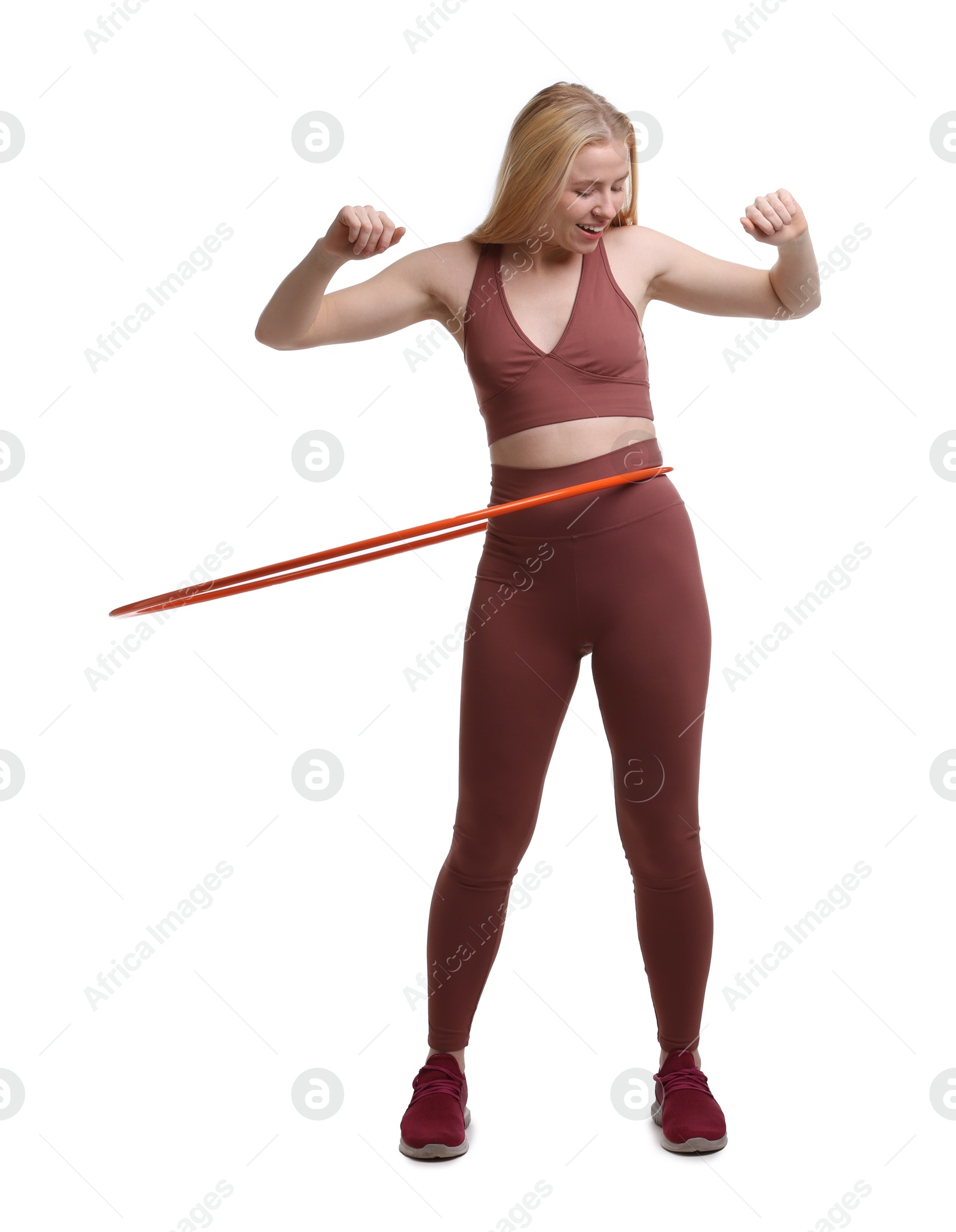 Photo of Beautiful young woman exercising with hula hoop on white background