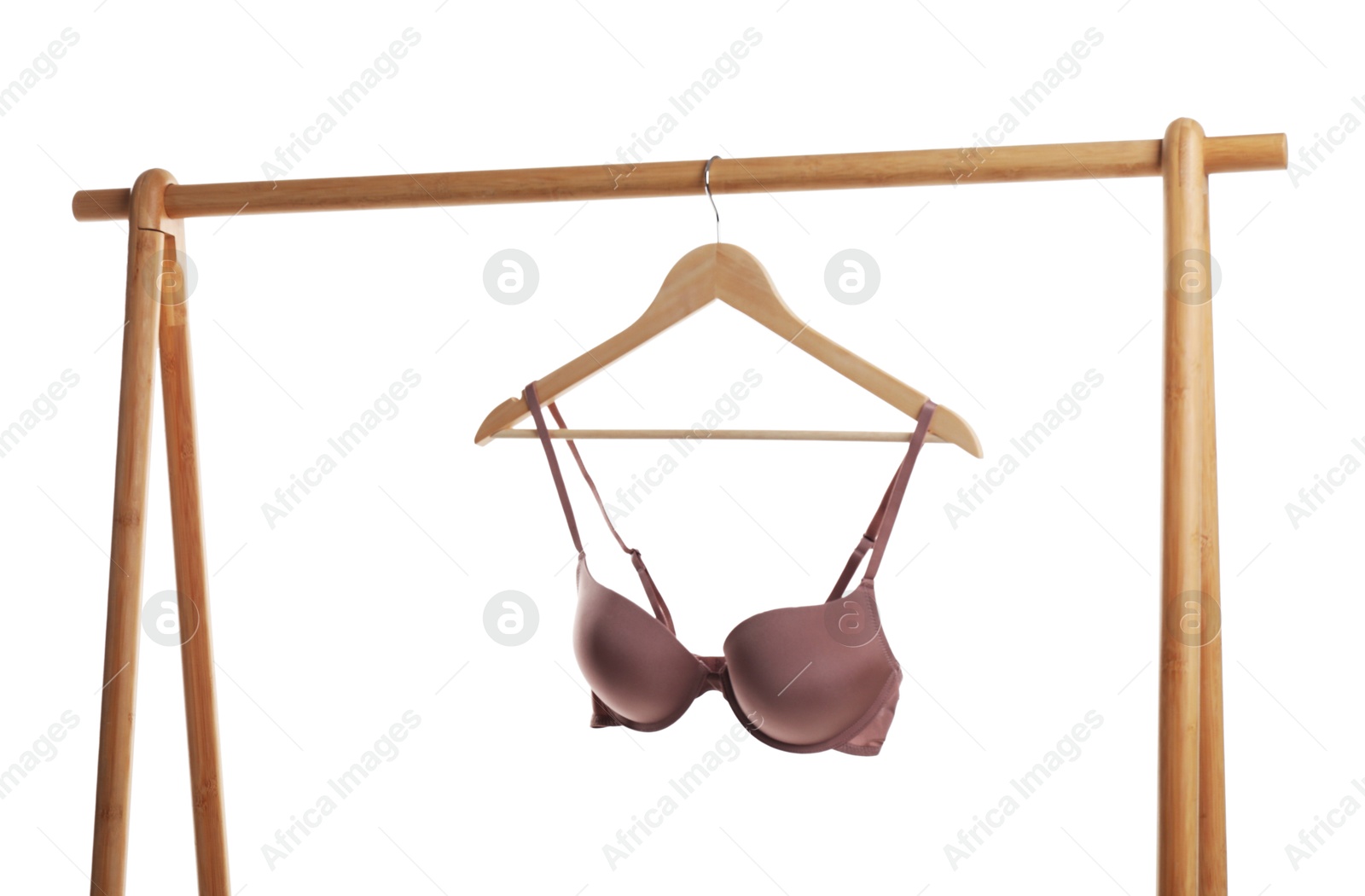 Photo of Hanger with dark beige bra on wooden rack against white background