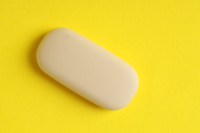 Photo of One eraser on yellow background, top view