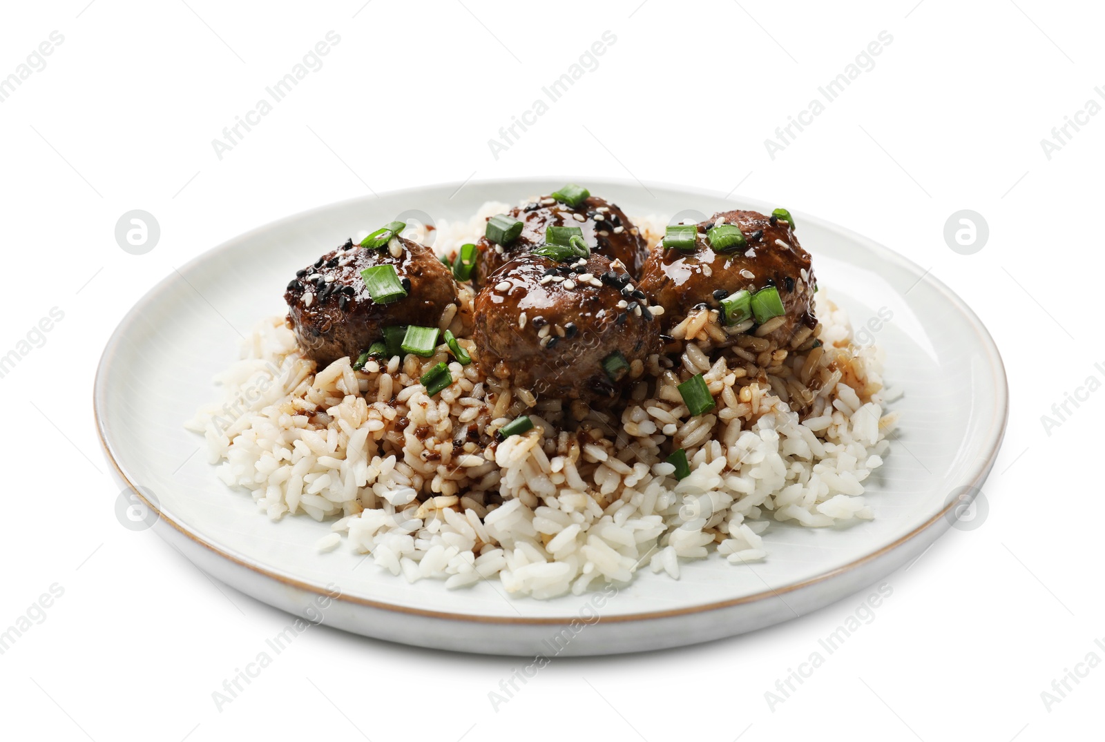 Photo of Delicious rice with meatballs, sauce and green onions isolated on white