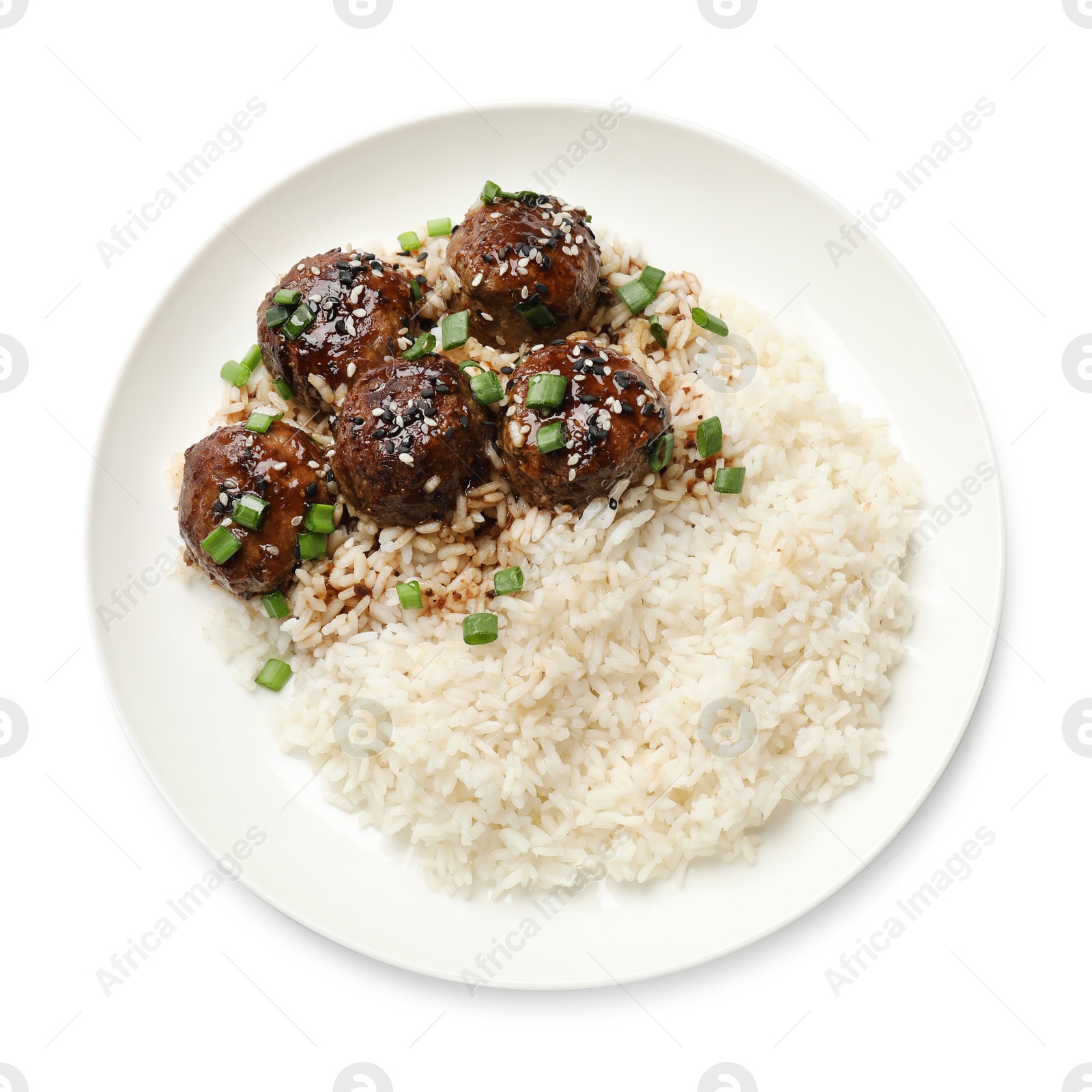 Photo of Delicious rice with meatballs, sauce and green onions isolated on white, top view