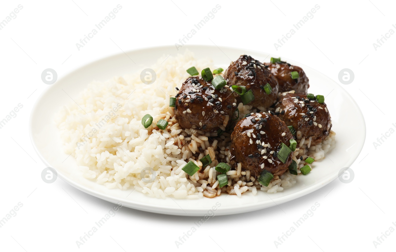 Photo of Delicious rice with meatballs, sauce and green onions isolated on white