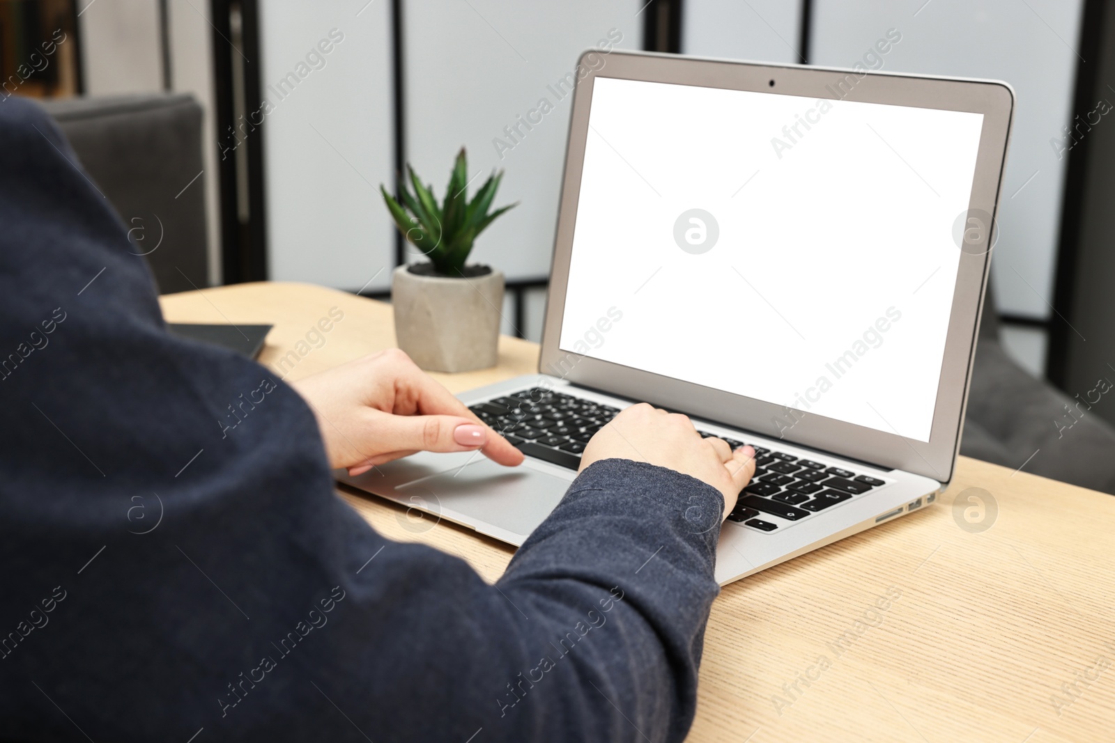 Photo of Woman working on computer at desk indoors, closeup