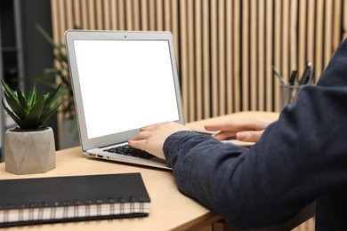 Photo of Woman working on computer at desk indoors, closeup