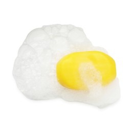 Photo of Yellow soap with foam on white background, top view