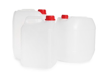 Photo of Three plastic canisters with caps isolated on white