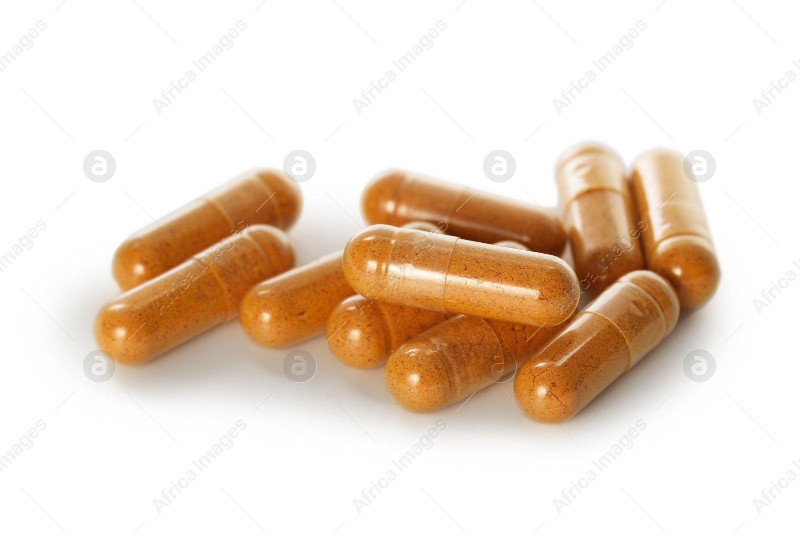 Photo of Many turmeric capsules isolated on white. Herbal dietary supplement