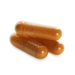 Photo of Three turmeric capsules isolated on white. Herbal dietary supplement