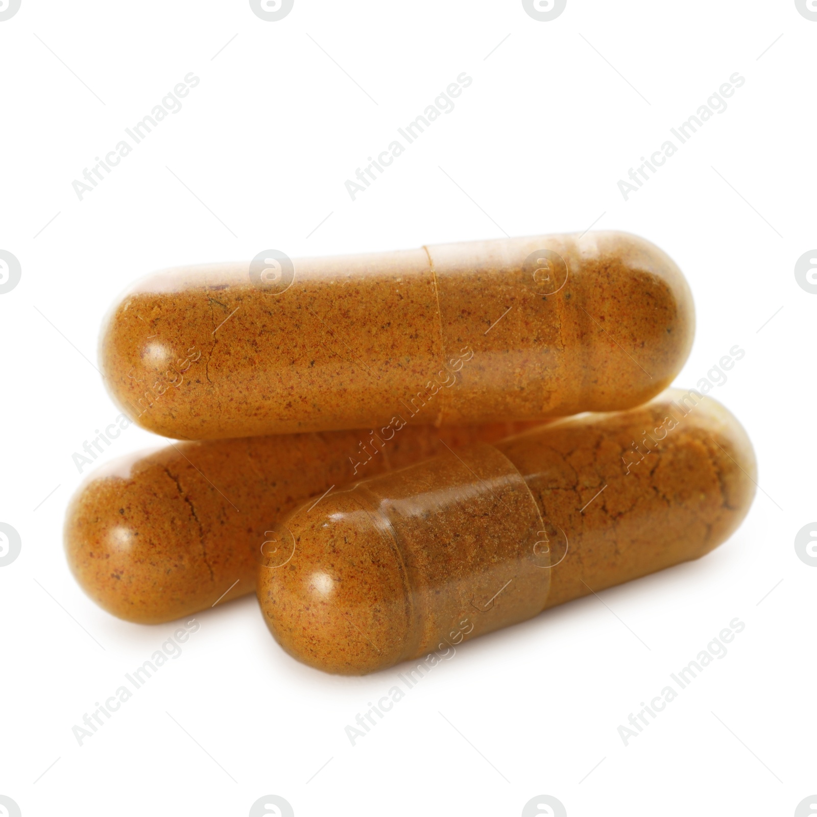 Photo of Three turmeric capsules isolated on white. Herbal dietary supplement