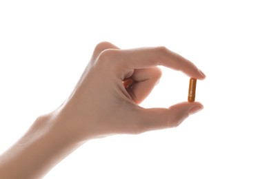 Photo of Woman with turmeric capsule on white background, closeup