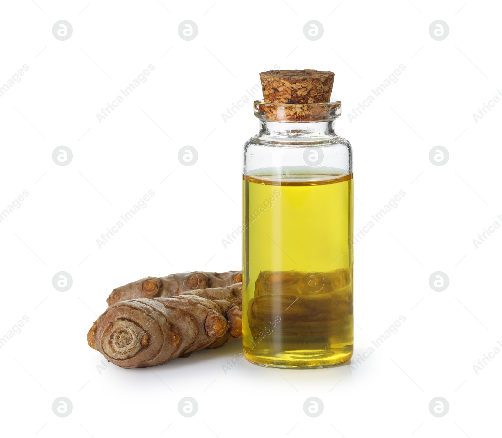 Photo of Bottle of turmeric essential oil and raw roots isolated on white