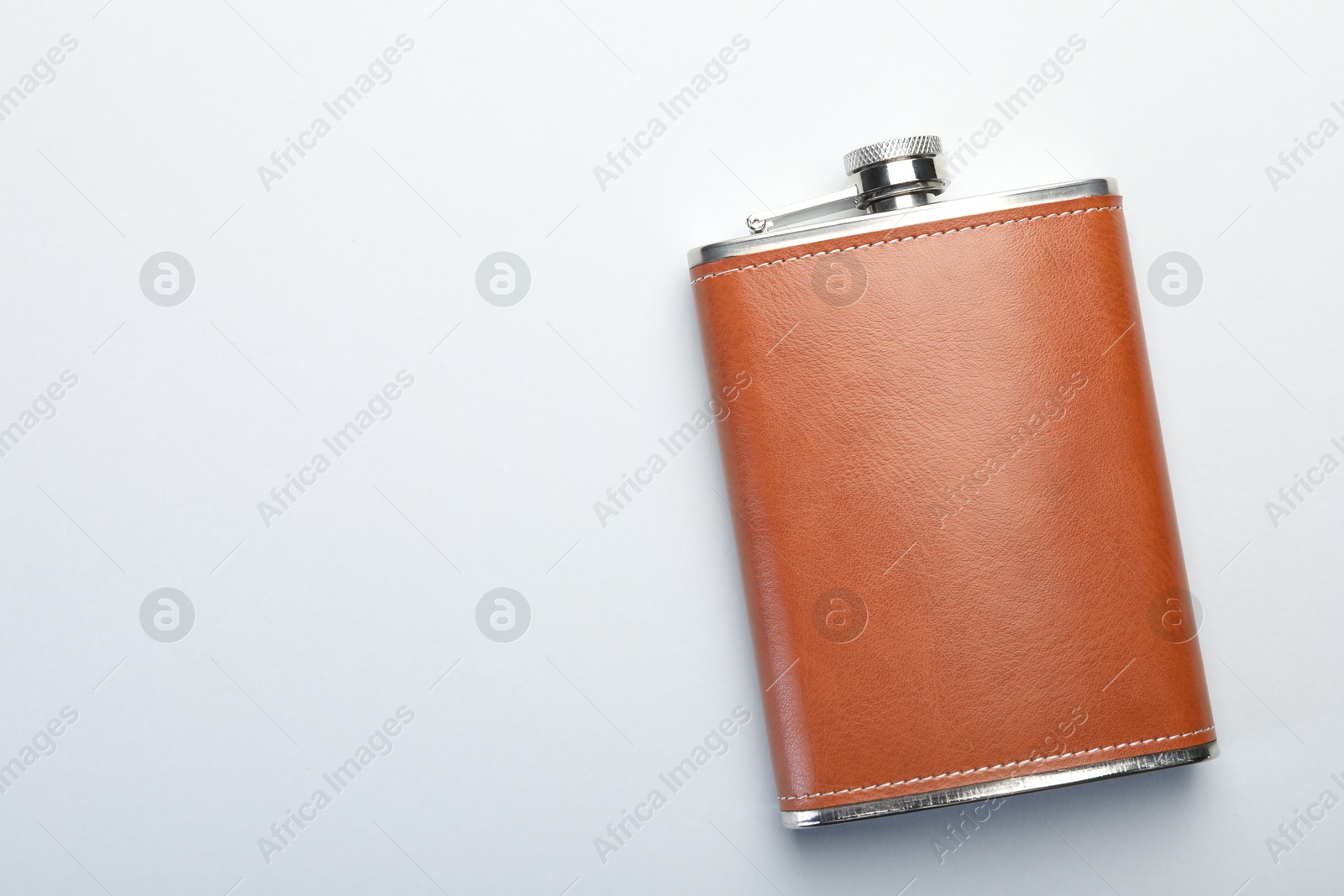 Photo of One hip flask on white background, top view. Space for text