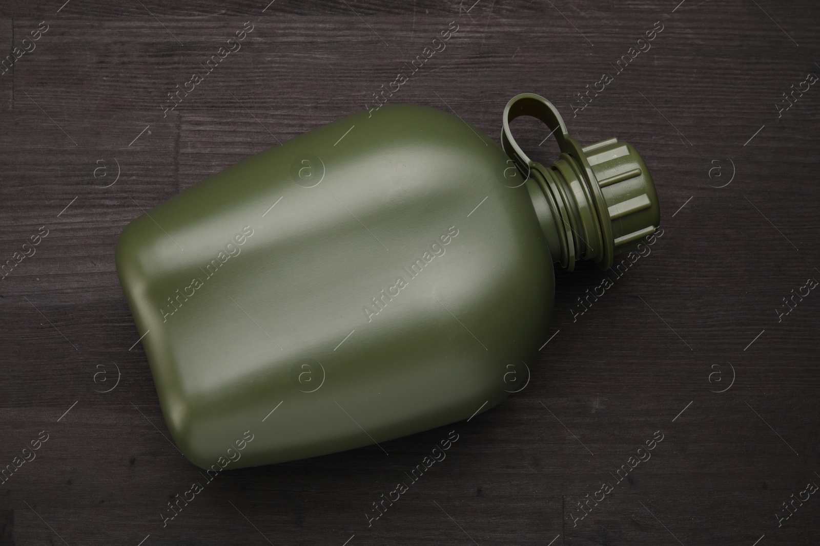 Photo of Green plastic canteen on wooden table, top view