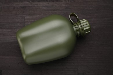 Photo of Green plastic canteen on wooden table, top view