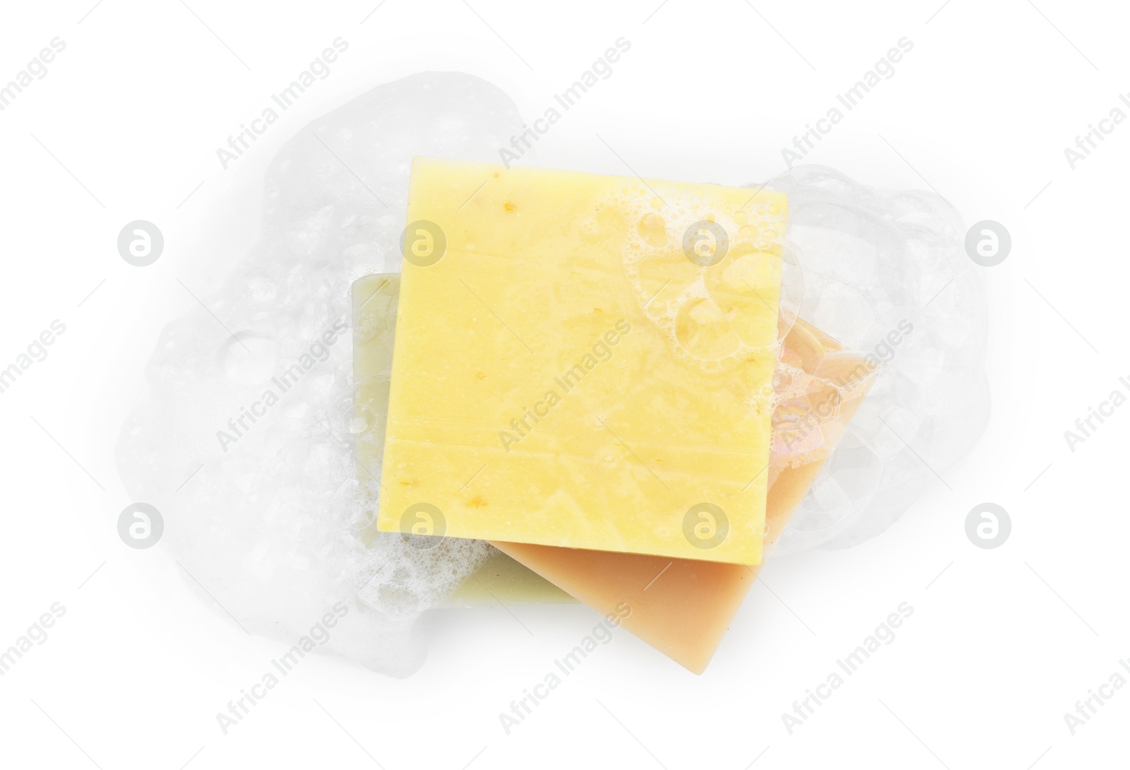 Photo of Stack of soap bars with foam on white background, top view