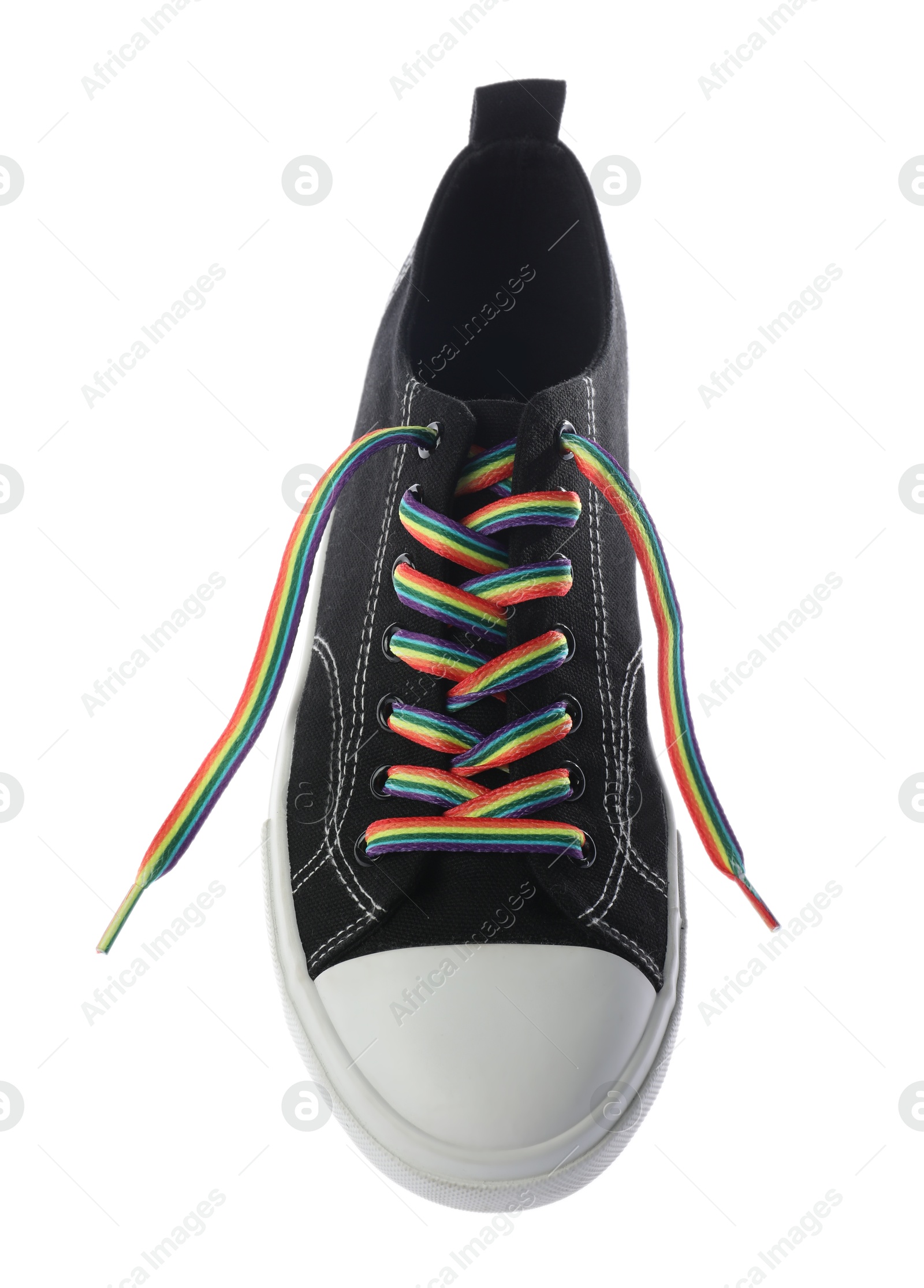 Photo of Black shoe with bright rainbow lace on white background, above view. LGBT concept