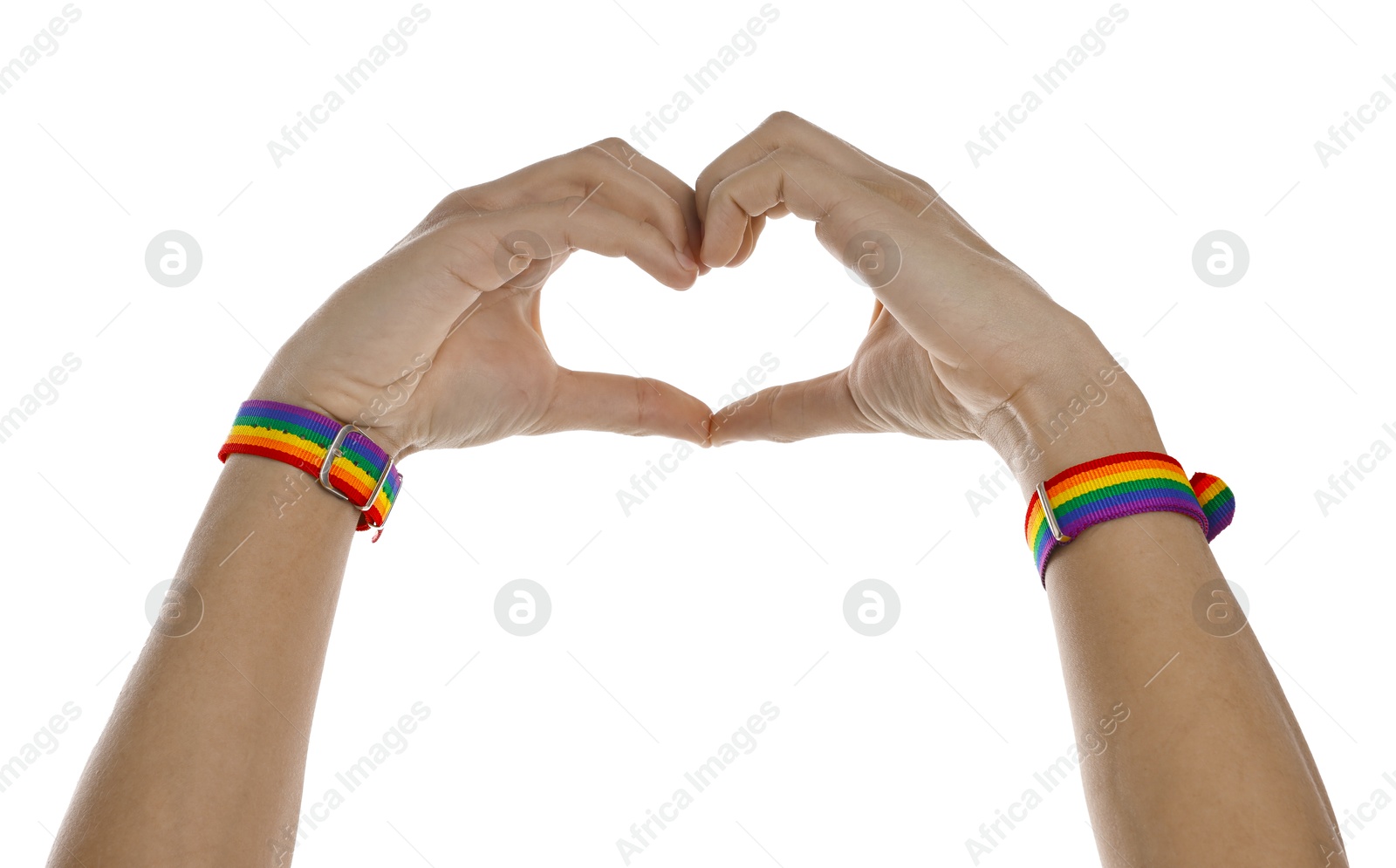 Photo of Man with bracelets in colors of LGBT flag making heart gesture on white background, closeup