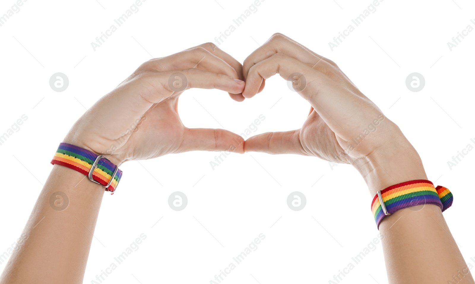 Photo of Man with bracelets in colors of LGBT flag making heart gesture on white background, closeup