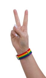 Photo of Woman wearing wristband in LGBT colors and showing peace sign on white background, closeup