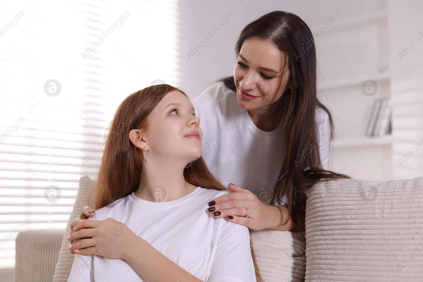 Photo of Portrait of beautiful mother with teenage daughter at home