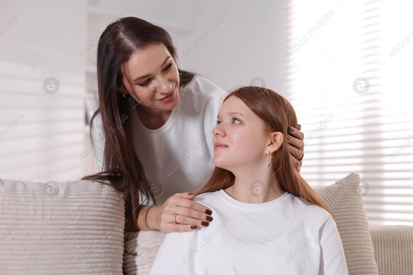 Photo of Portrait of beautiful mother with teenage daughter at home