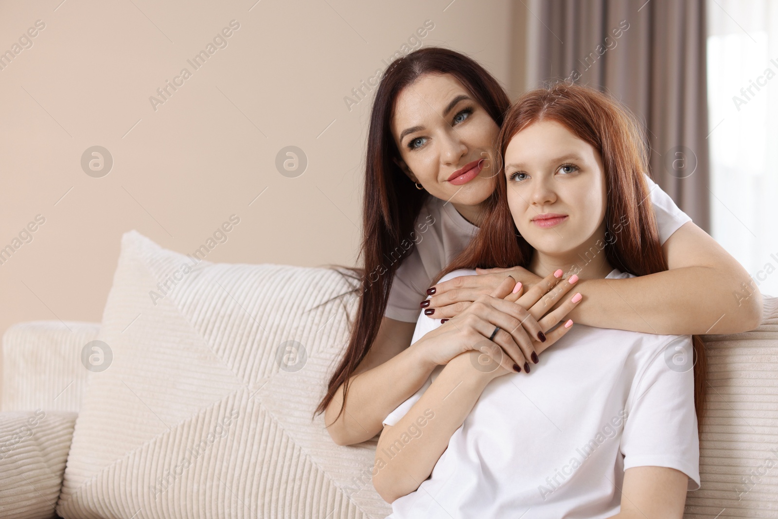 Photo of Portrait of beautiful mother with teenage daughter at home