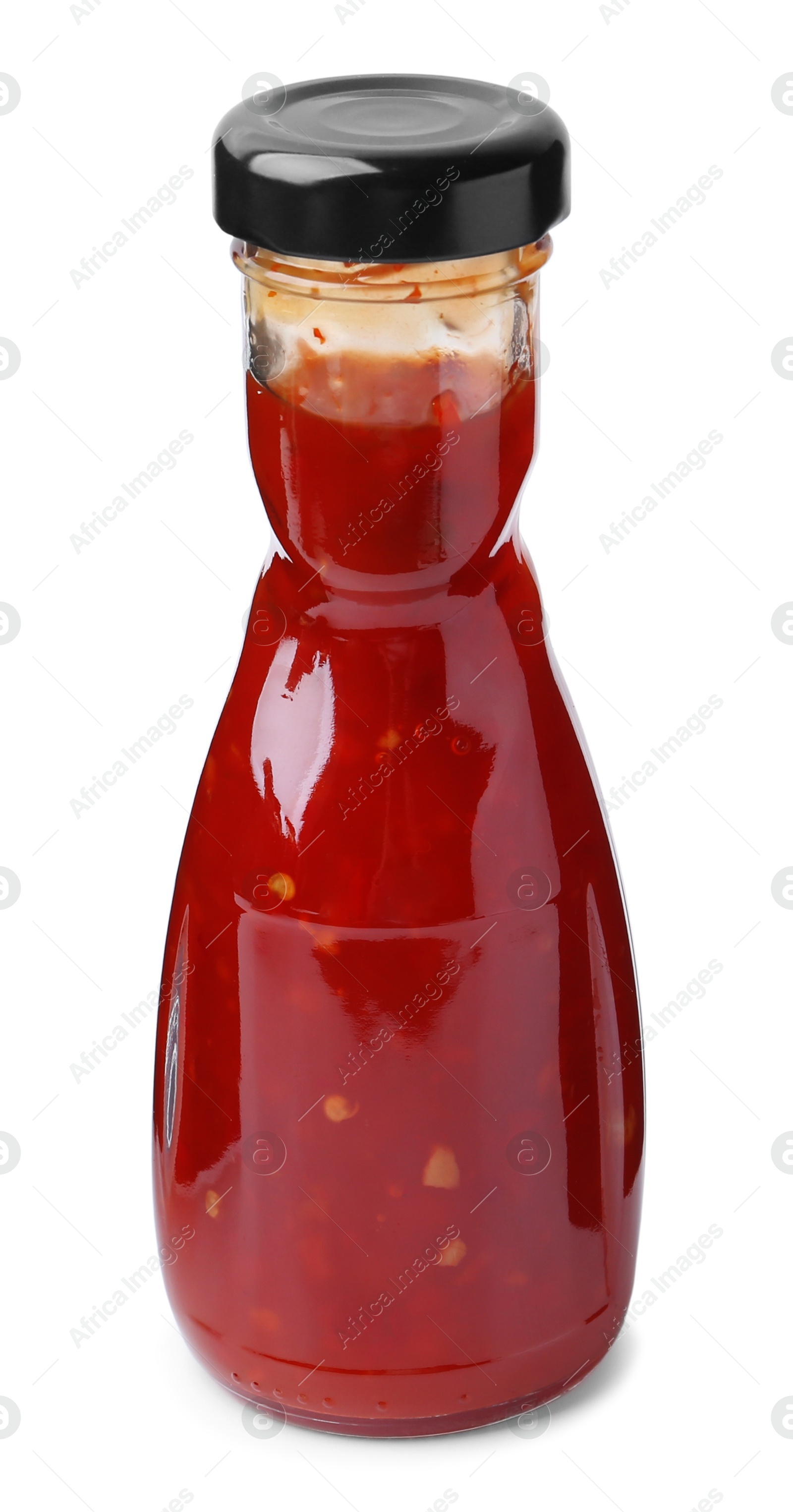 Photo of Delicious sauce in glass bottle isolated on white