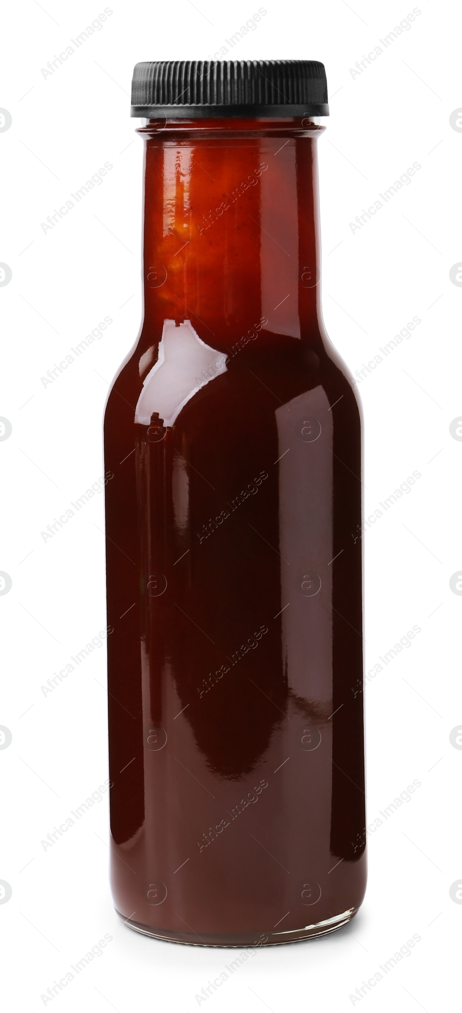 Photo of Delicious sauce in glass bottle isolated on white