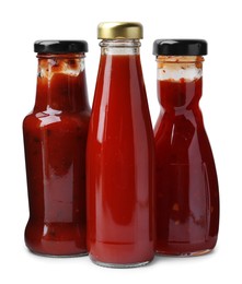 Photo of Different delicious sauces in glass bottles isolated on white