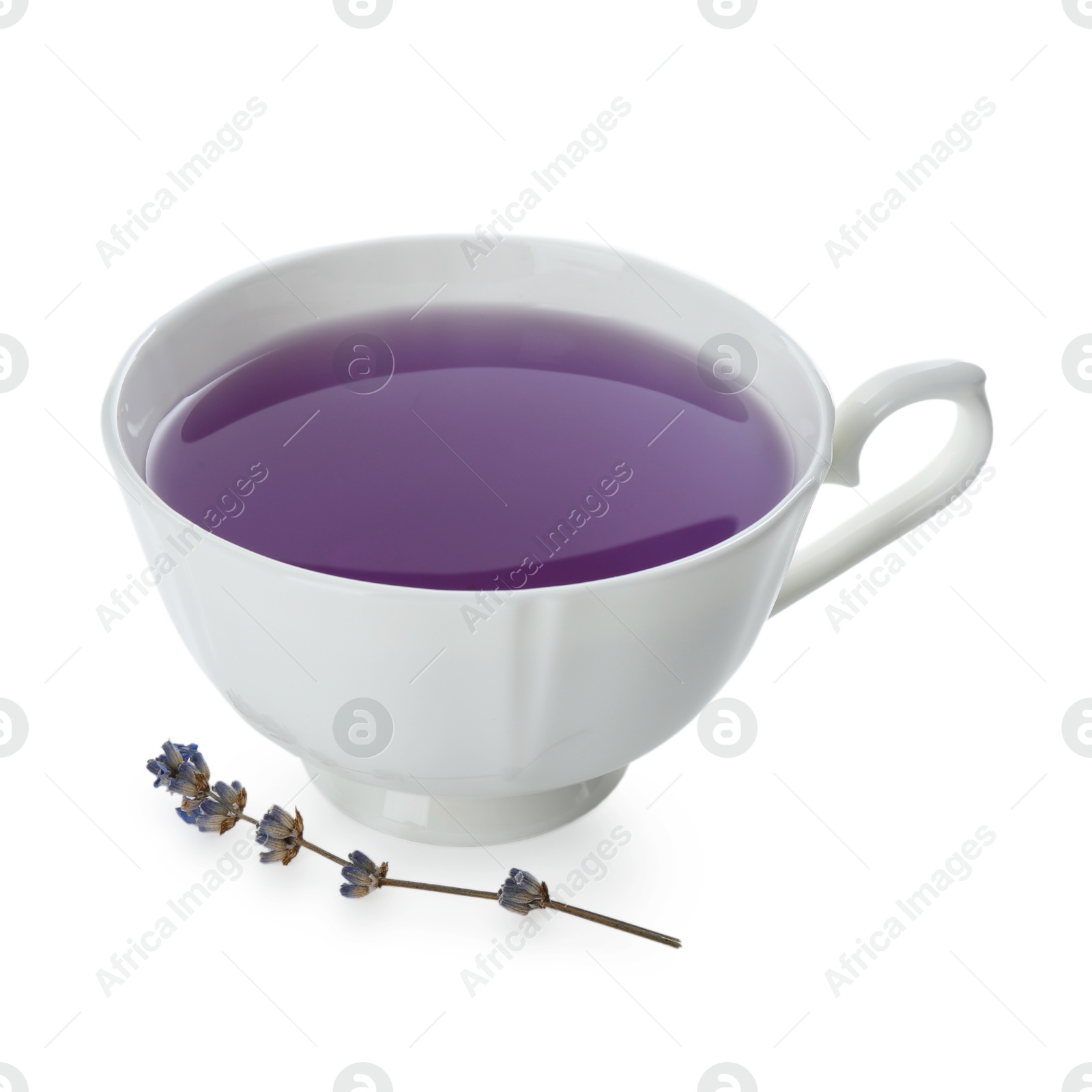 Photo of Aromatic lavender tea in cup and dry flowers isolated on white