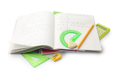 Photo of Doing homework. Notebook with math assignment and stationery on white background