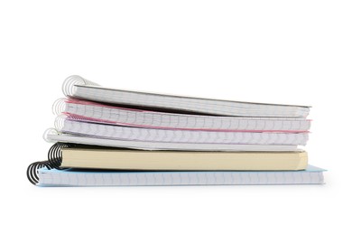 Photo of Stack of different notebooks isolated on white