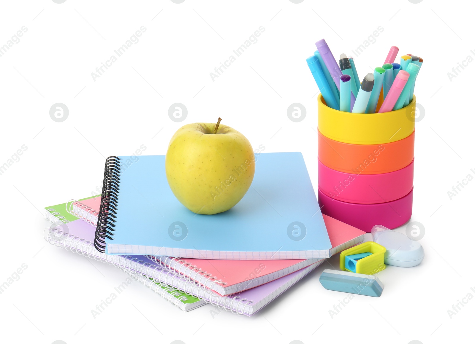 Photo of Doing homework. Notebooks, apple and stationery on white background