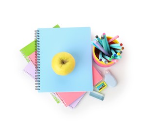 Photo of Notebooks, apple and different stationery isolated on white, top view