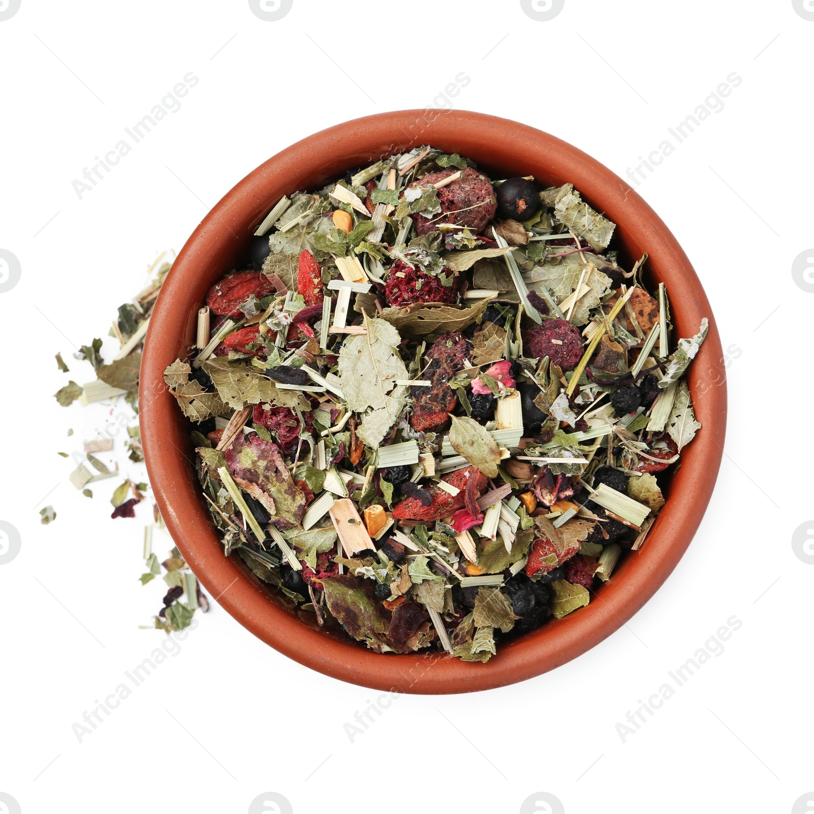 Photo of Dry herbal tea brew in bowl isolated on white, top view