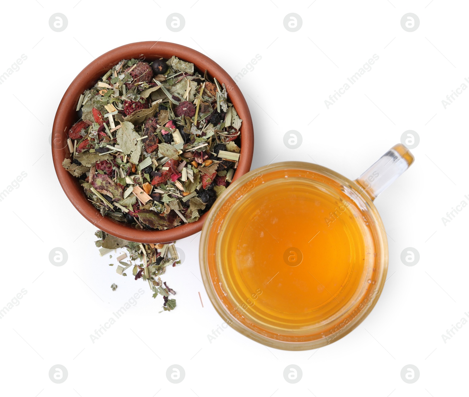 Photo of Delicious herbal tea and dry leaves isolated on white, top view