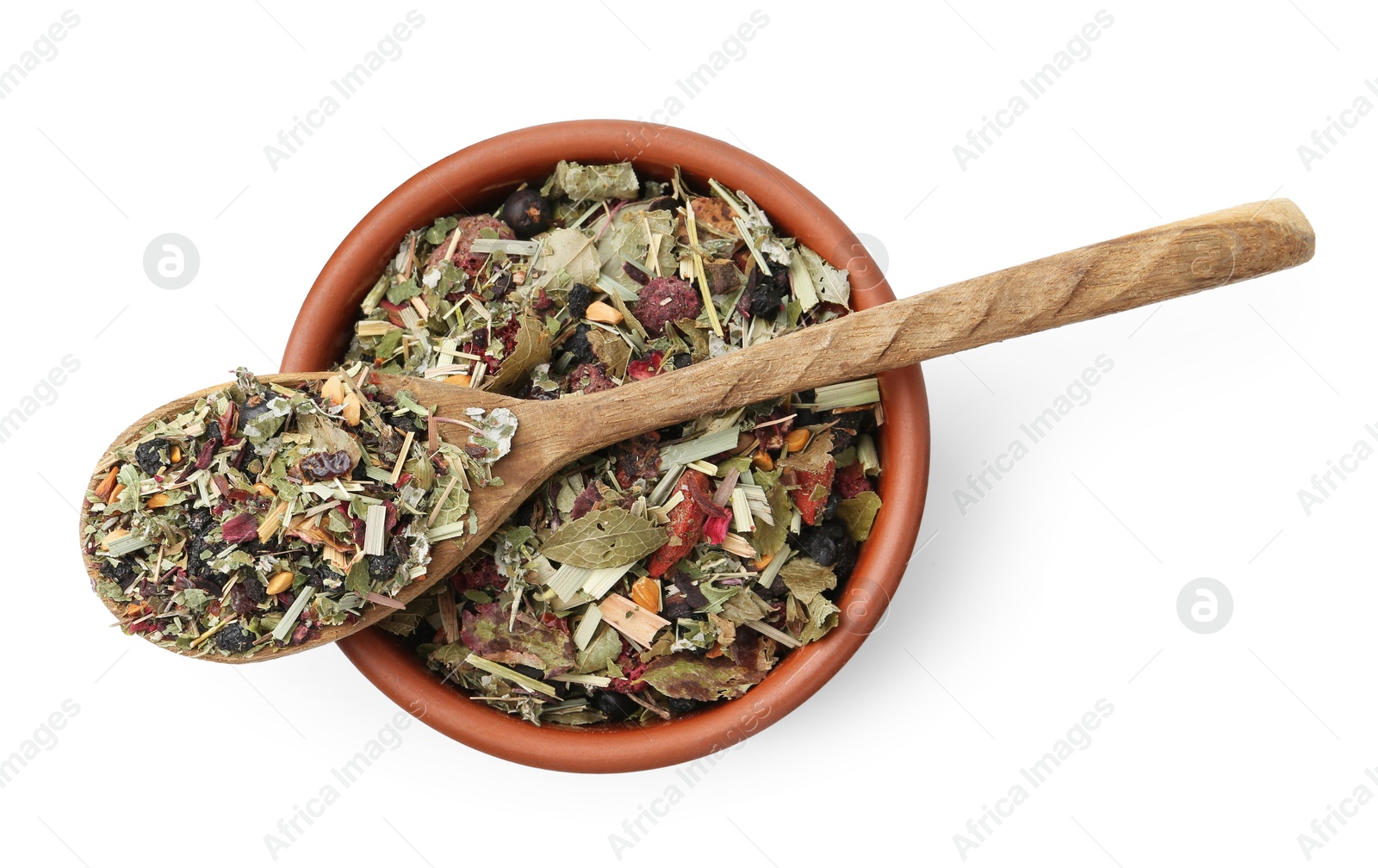 Photo of Dry herbal tea brew in bowl with spoon isolated on white, top view