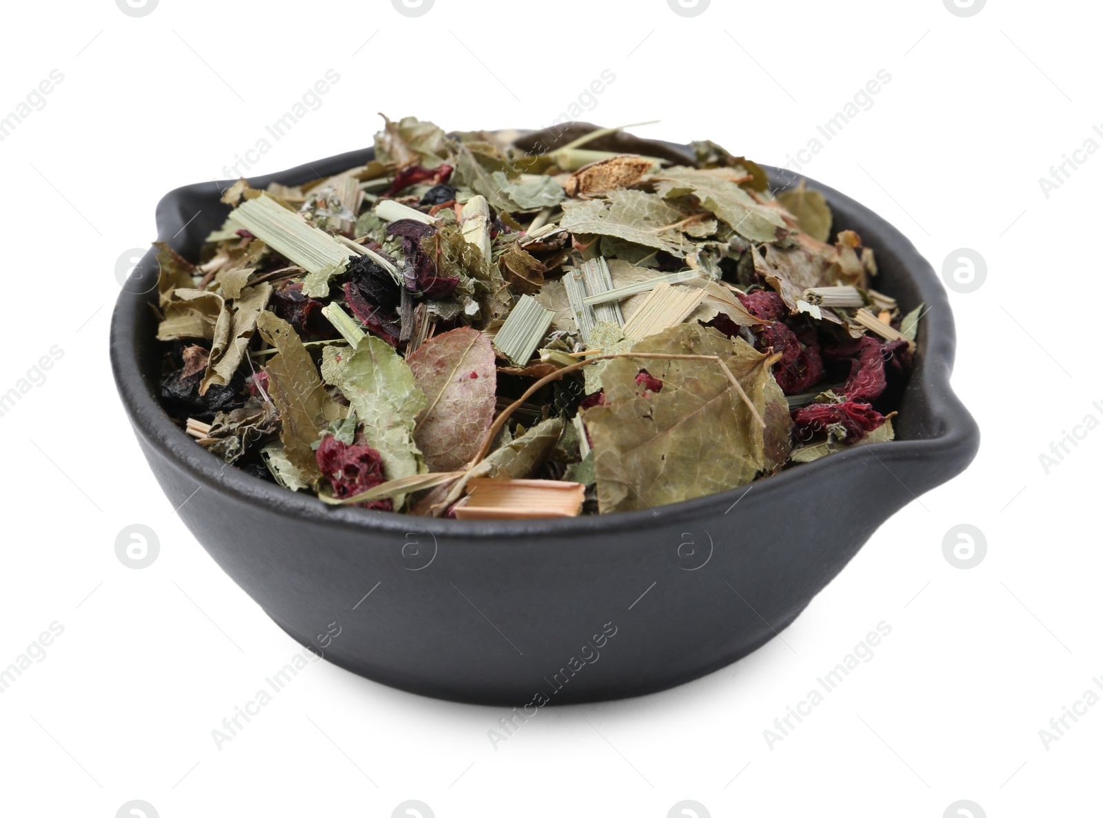 Photo of Dry herbal tea brew in bowl isolated on white