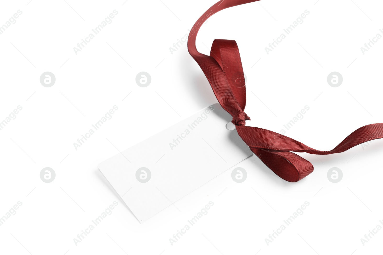 Photo of Blank tag with ribbon bow isolated on white