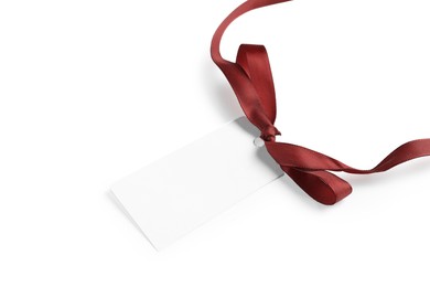 Photo of Blank tag with ribbon bow isolated on white