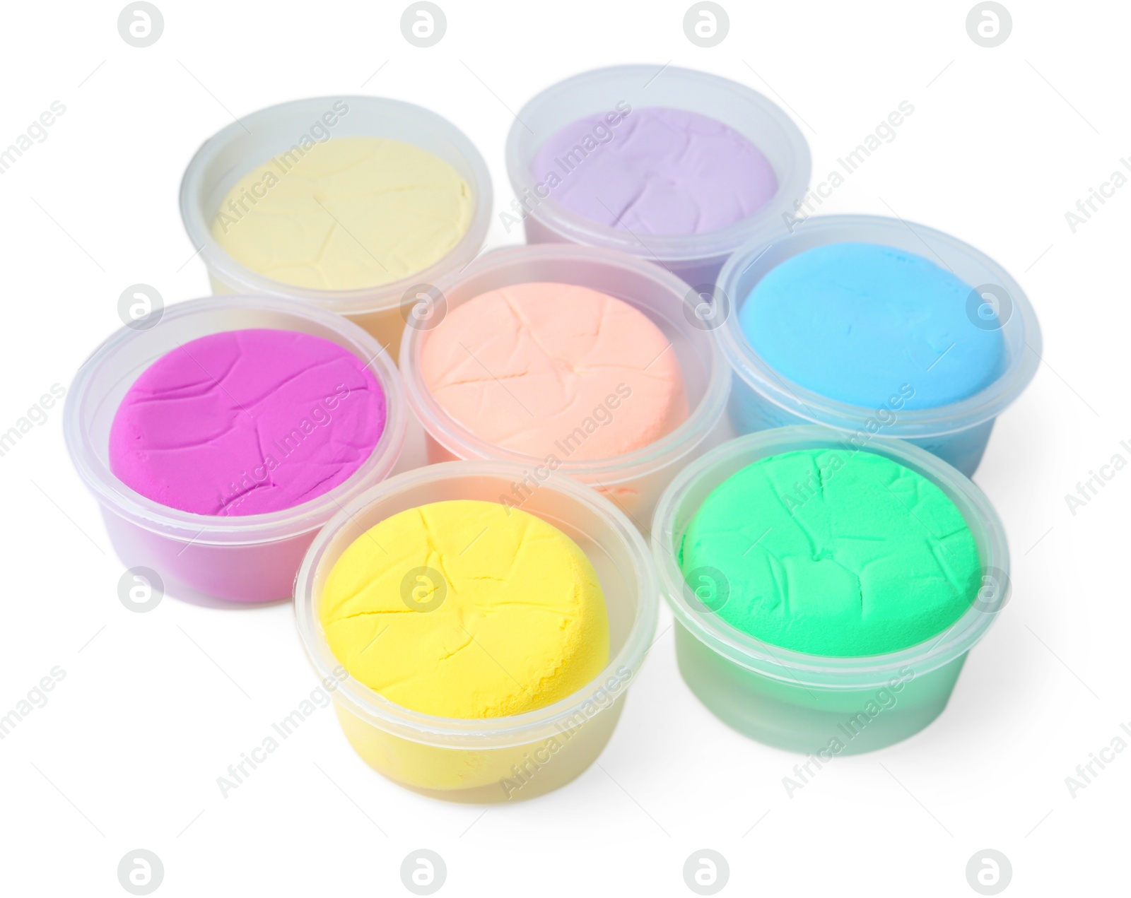 Photo of Different colorful modeling clay in plastic jars isolated on white