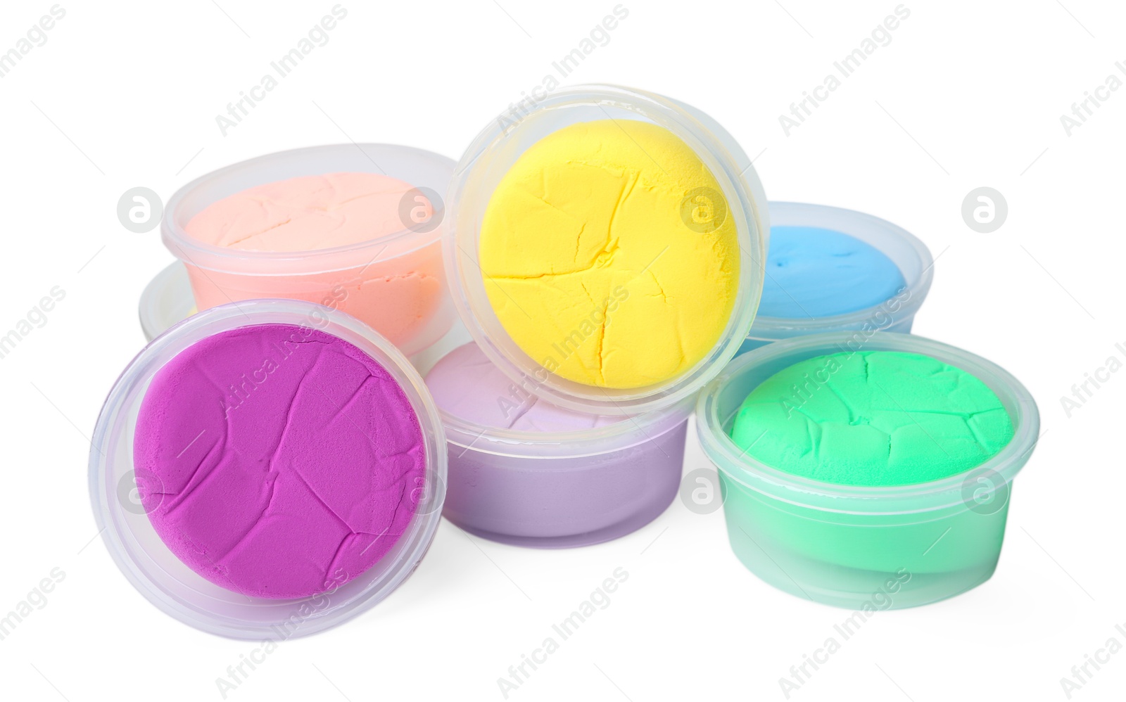 Photo of Different colorful modeling clay in plastic jars isolated on white