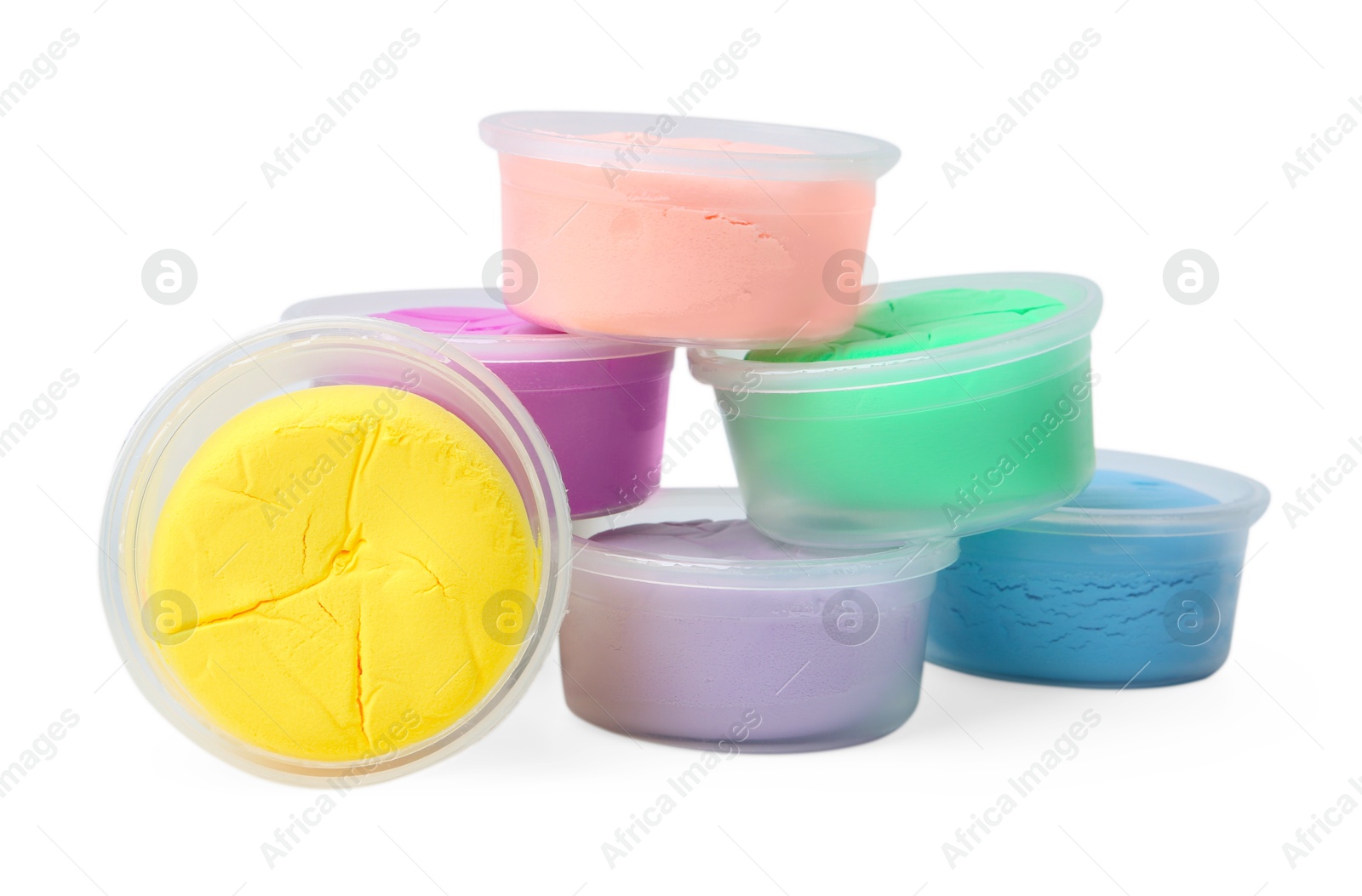 Photo of Different colorful modeling clay in plastic jars isolated on white