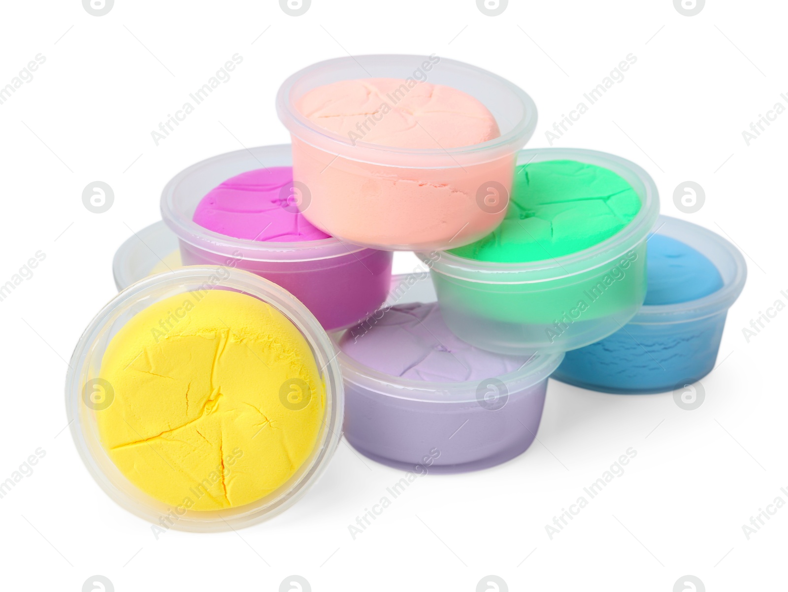 Photo of Different colorful modeling clay in plastic jars isolated on white