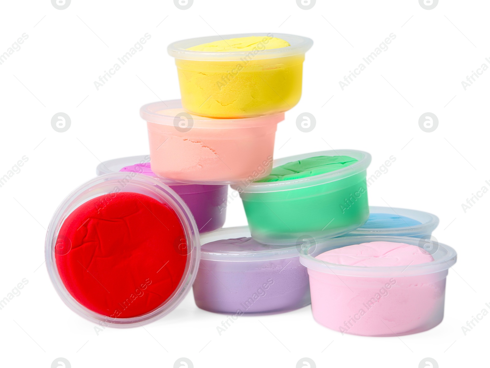 Photo of Different colorful modeling clay in plastic jars isolated on white