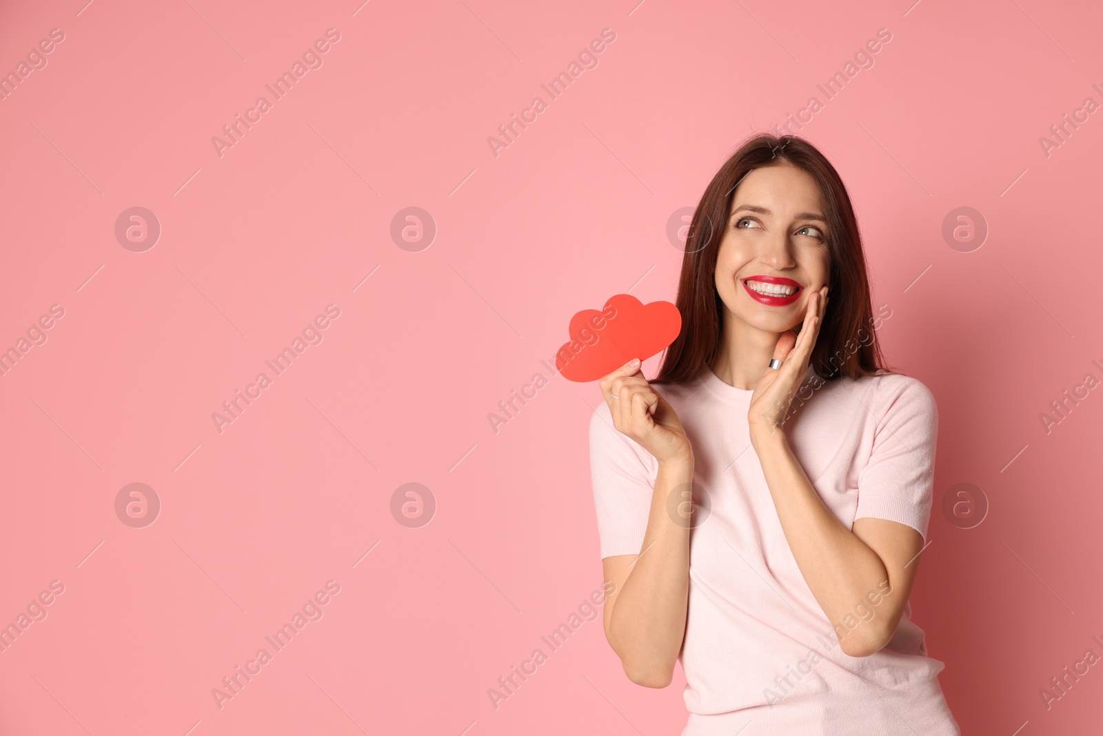 Photo of Happy Valentine's Day. Beautiful woman with paper hearts on pink background. Space for text