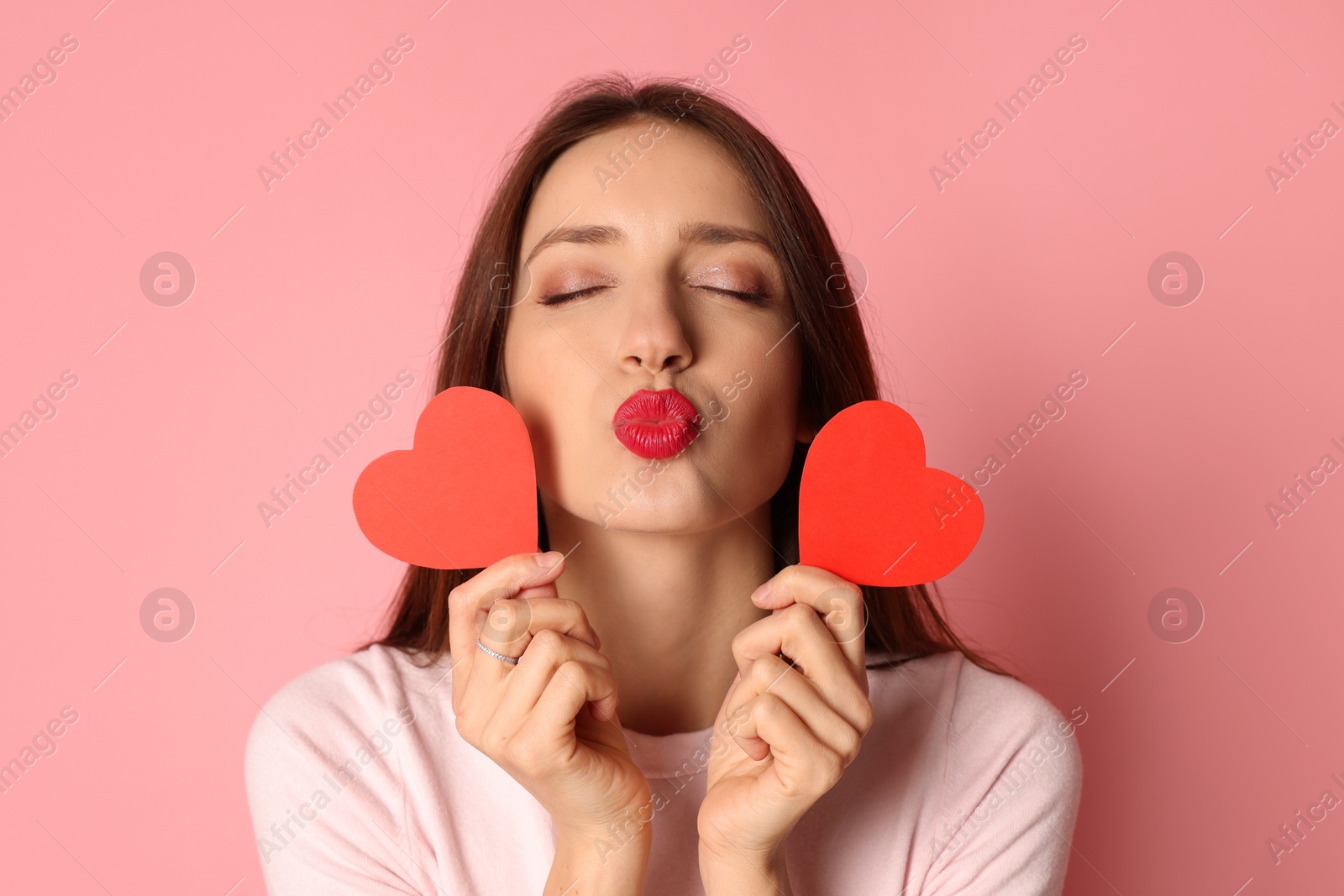 Photo of Happy Valentine's Day. Beautiful woman with paper hearts on pink background