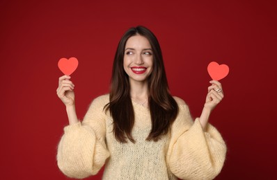 Photo of Happy Valentine's Day. Beautiful woman with paper hearts on red background