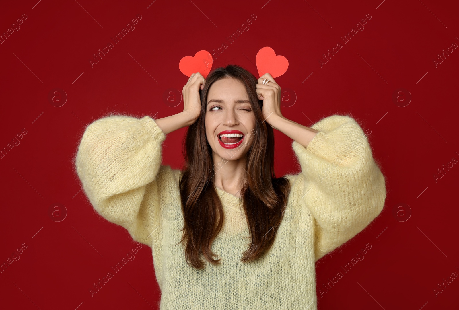 Photo of Happy Valentine's Day. Beautiful woman with paper hearts on red background